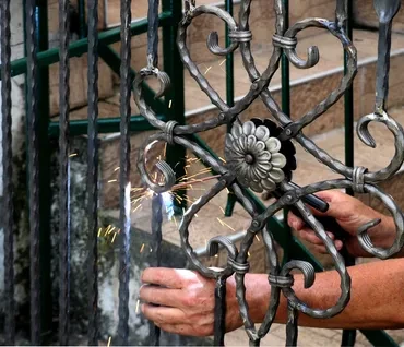 Welding ornamental iron gate repair with sparks
