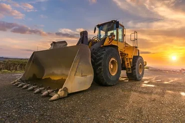 Yellow wheel loader at sunset on job site York PA